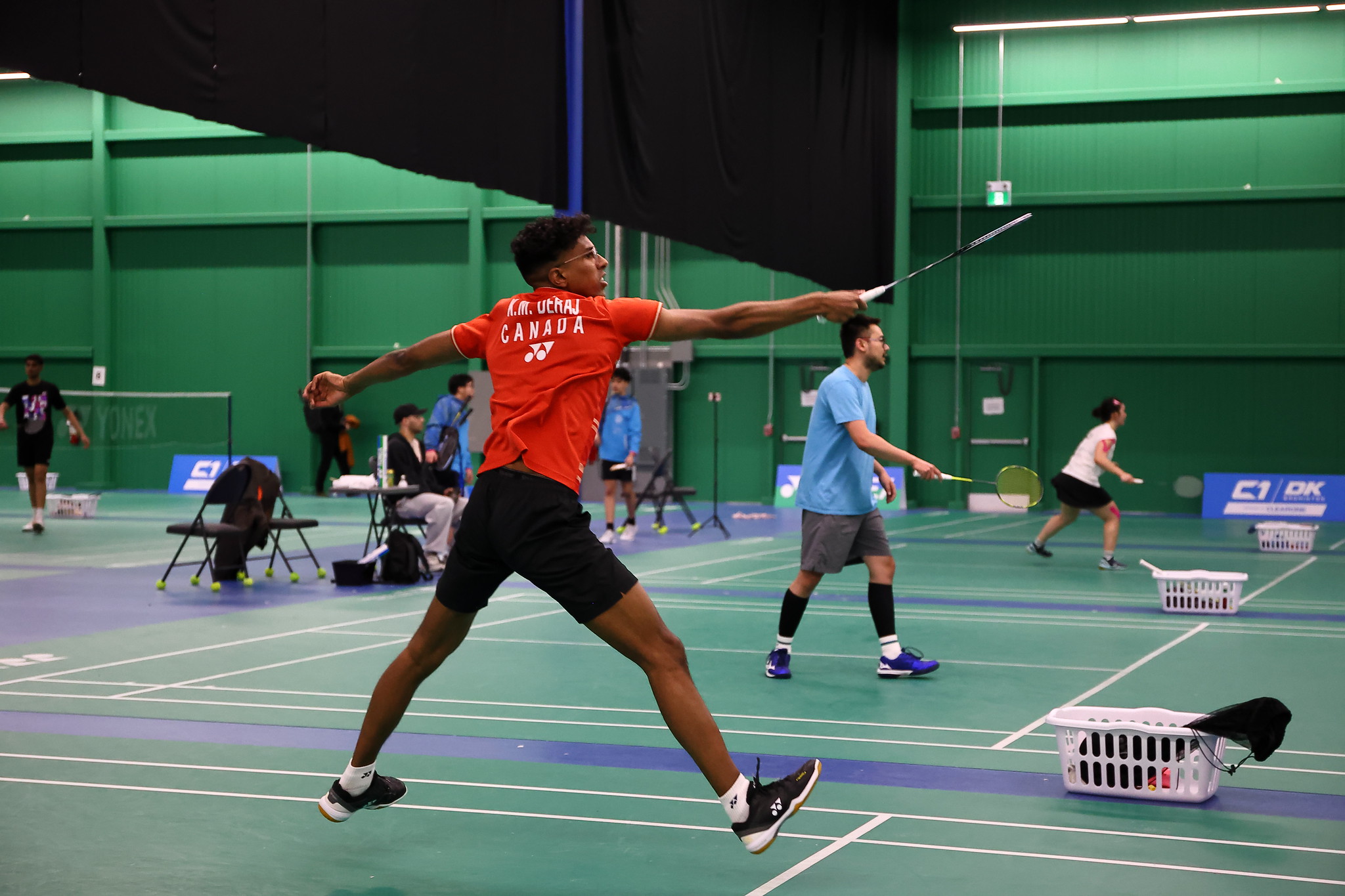 Badminton player jumping for an overhead smash at the 2026 Provincial Seniors tournament