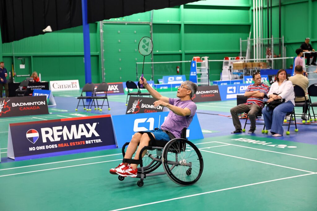 Wheelchair para-badminton player returning a shot during the 2026 Yonex Canadian Senior & Para Championships